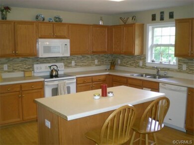 The light and bright Kitchen features hardwood flo