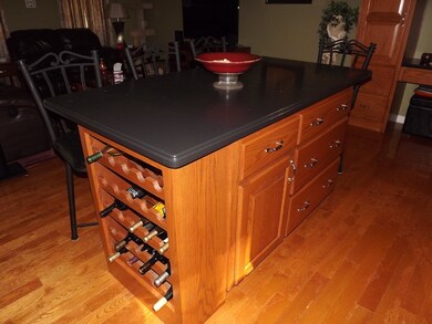 Large center island with large wine rack on end, a