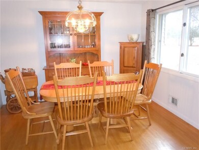 DINING ROOM WITH GLEEMING HARDWOOD FLOOR OPEN TO K