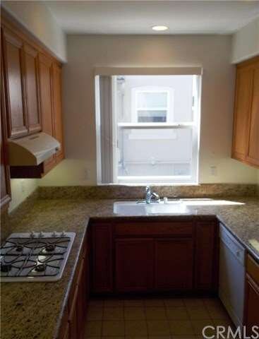 Bright kitchen with recessed lighting opens up on 