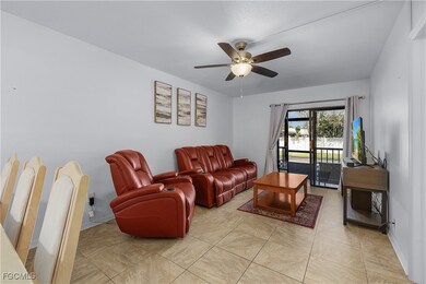 Living area with light tile patterned flooring and a ceiling fan