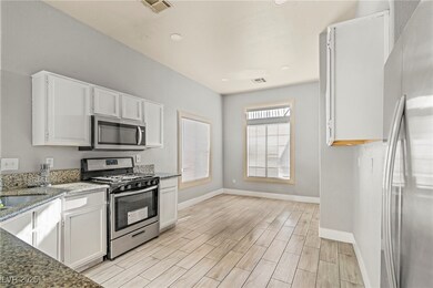 Kitchen with stainless steel appliances, baseboard