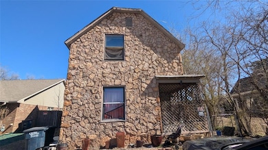 View of side of property with stone siding and fen