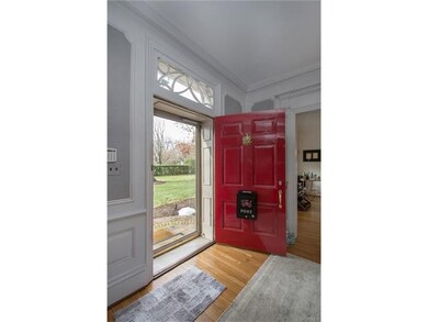 Elaborate entry with solid raised panel door with 