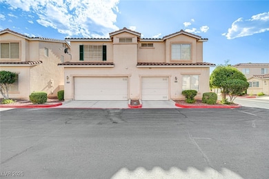 View of front facade with a tile roof, a garage, s