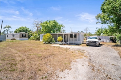 View of front of house with a sunroom, gravel driv