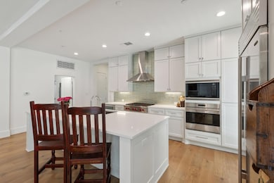 Kitchen with light hardwood / wood-style floors, w
