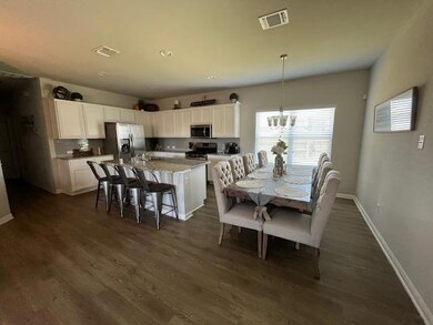 Dining space featuring a chandelier and dark wood