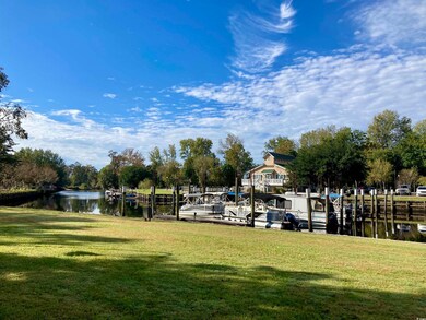 View of yard featuring a water view and a boat doc
