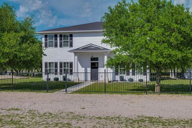 View of front facade with a fenced front yard and