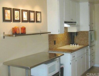 The opposite side of the kitchen has newer oven an
