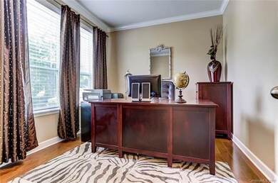 Office with Wood Flooring and Crown Molding