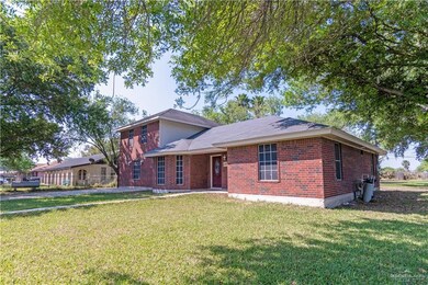 View of front of house with brick siding and a front lawn