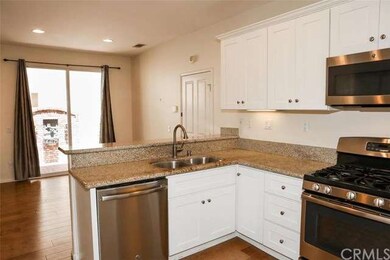 The kitchen also features stainless steel applianc