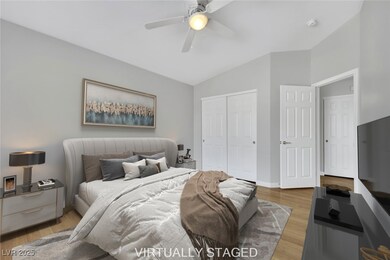 Bedroom featuring ceiling fan, baseboards, vaulted