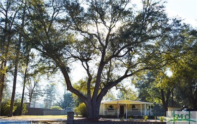 The welcoming brick entrance, majestic oaks, crush