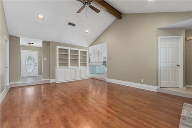 Unfurnished living room with ceiling fan, wood fin