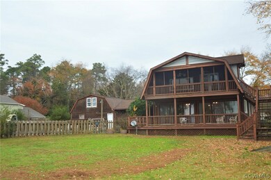 Rear of home with pool, and two decks.  Top deck off master is screened in porch.