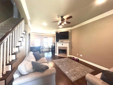 Living room with crown molding, dark hardwood / wo
