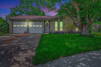 Ranch-style house with concrete driveway, a garage, and a lawn
