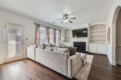 Living room with a fireplace with raised hearth, c