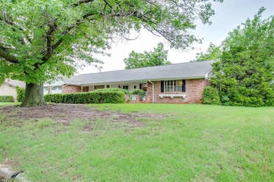 Ranch-style home with brick siding and a front lawn