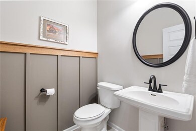 Half bathroom with toilet and a sink