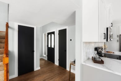 Hall with stairs and wood finished floors