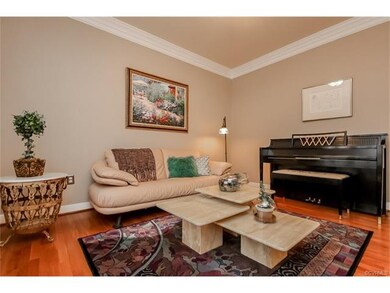 Formal living room with crown moldings and gleamin