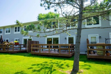 Rear view of property with a lawn and a wooden dec
