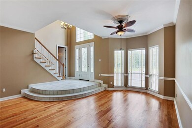 Impressive grand entry foyer opens to beautiful wo