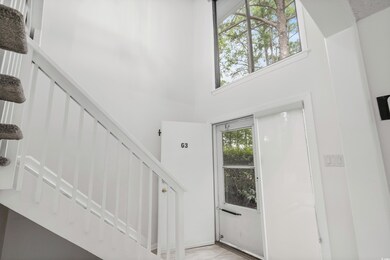 Entrance foyer with stairs and a towering ceiling