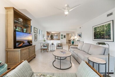 Living room featuring visible vents, ornamental mo