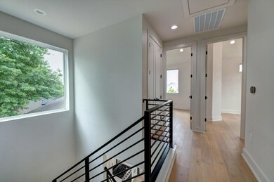 Corridor featuring attic access, an upstairs land