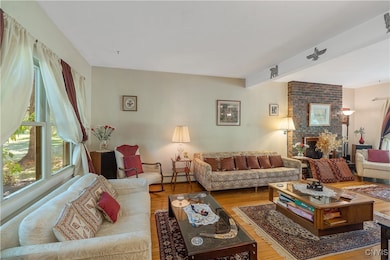 Stepping down into the living room you are greeted by gleaming hardwoods and tons of natural light. The room runs from the front to the back of the house.