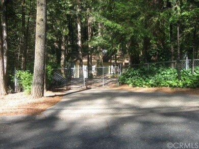 Gated  circular drive, fenced yard. 