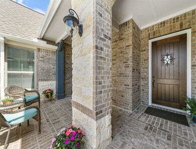 Your guests will feel so welcomed as they enter through the wrought iron gate, and see this front porch/courtyard like area.