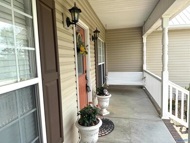 Sit out here on this very nice porch swing and enjoy your day in this country setting.