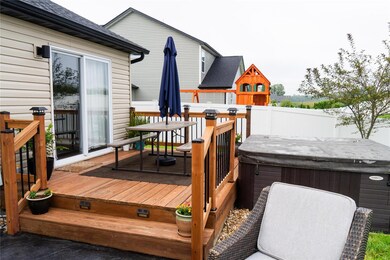 Back deck with access to an Aspen Spas Hot Tub