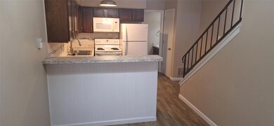 Kitchen with visible vents, dark wood-type floorin