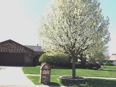 Professionally landscaped yard features many bloom