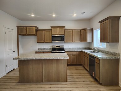 The kitchen has staggered knotty alder cabinets, granite countertops and stainless steel appliances.