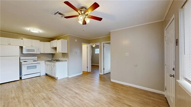 Kitchen featuring white appliances, a ceiling fan,