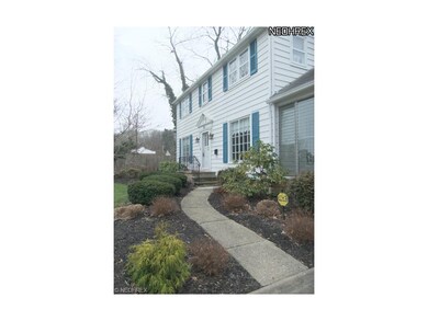 The manicured front walkway leads up to the entran