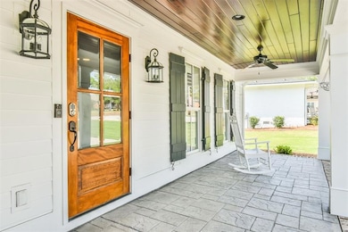 View of exterior entry featuring covered porch and