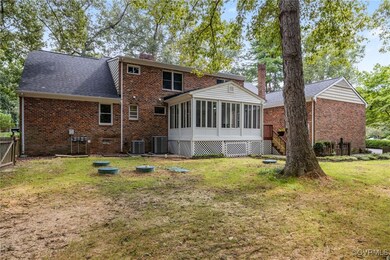 Back of house featuring a sunroom, central AC unit
