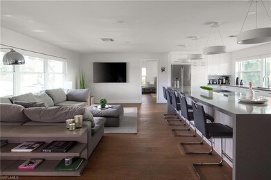 Living room with sink and dark hardwood / wood-sty