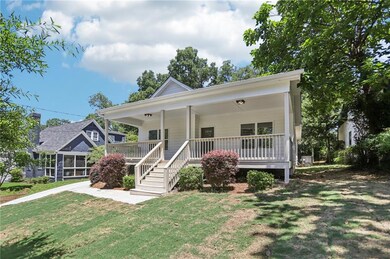 View of front of home with a front lawn and covered porch