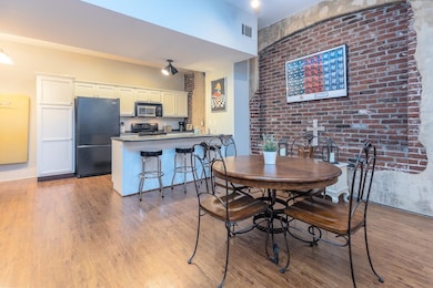 Dining area with visible vents and wood finished floors