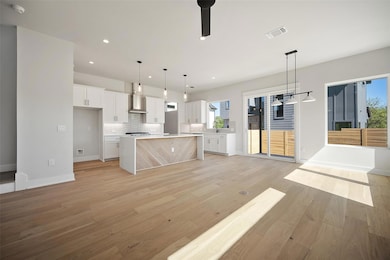Kitchen with visible vents, backsplash, wall chim